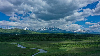Picturesque landscape with river and volcano. Kamchatka peninsula