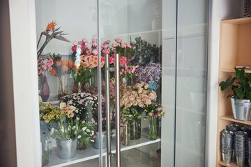Fototapeta na wymiar Stunning spring flowers in glass jars and galvanized metal buckets