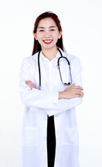 Smiling professional young Asian female physician in medical robe with stethoscope looking at camera while standing against white background.