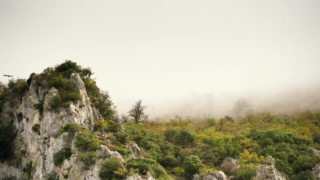 Cloudy mountains and birds flying over rocks. Agurain, Basque Country, Spain.