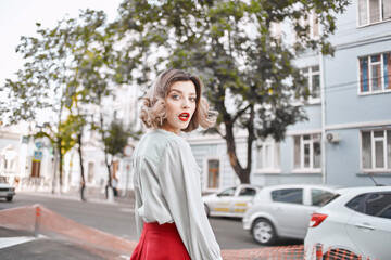 Fototapeta na wymiar pretty woman outdoors red lips walk lifestyle posing