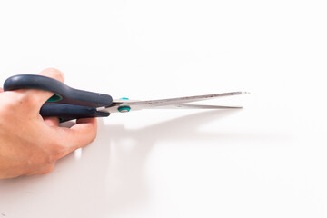 scissors in hand on a white background