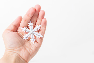 large snowflake on the hand on a white background