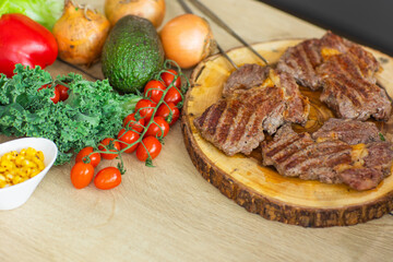 well done veal meat steak and vegetables on the kitchen table