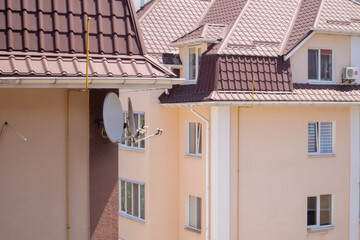 Roof on residential property with new brown corrugated metal roof tiles. Modern metal roof. Metal roofing.