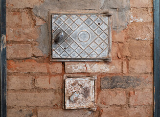 Fragment of an old brick oven. There is no plaster, cracks and traces of repair are visible. There...