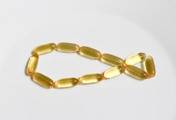 Capsules of omega 3 in the shape of a fish. Cod liver fish oil