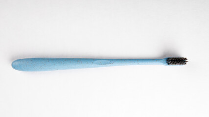 Blue toothbrush on a white background. Health and hygiene