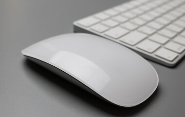 Wireless keyboard and mouse in white on a gray background. English-Russian letter layout. High quality photo