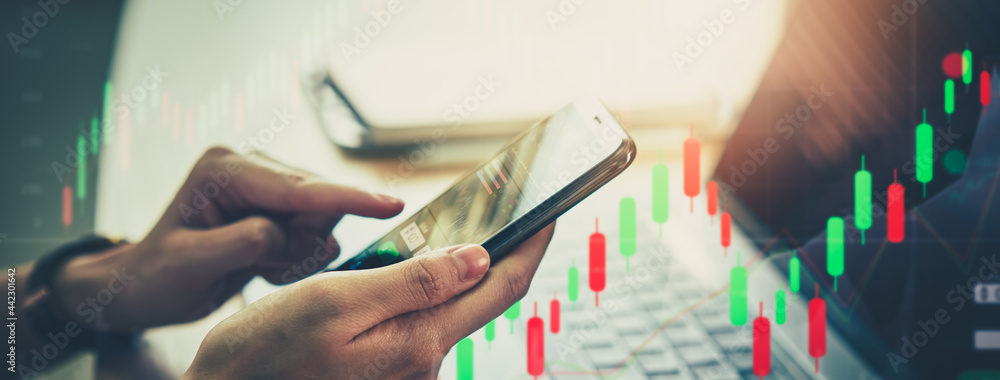 Poster stock exchange market concept, hand using smartphone with graphs analysis candle line on bokeh color