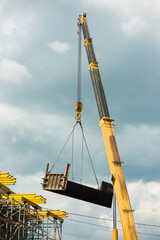 Truck crane lifts the formwork on the scaffolding