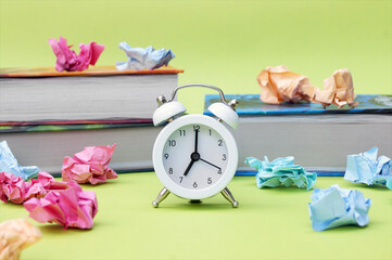 A white vintage clock in the foreground at 7:00 am on a light green background.
