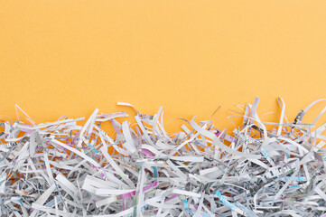 The shredded paper on light orange background.