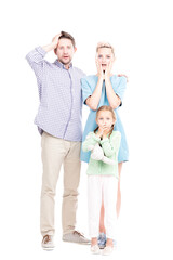 Fototapeta na wymiar Vertical full length shot of modern man and woman standing with their little daughter astonished at something, white background