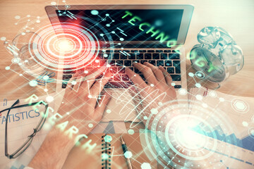 Double exposure of man's hands typing over computer keyboard and data theme hologram drawing. Top view. Technology concept.