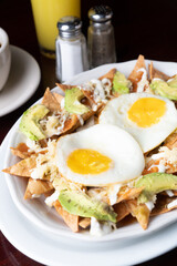 nachos with fried eggs with orange juices and coffee
