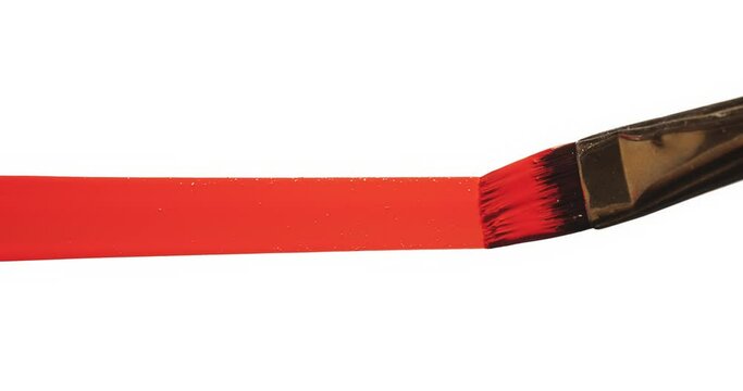 Artist drawing red line with paint brush on white background.
