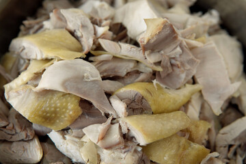 Closeup Heap Boiled piece of chopped cooked chicken with skin in a stainless steel pot after make sacrifice to Chinese gods. Healthy Food with no flavor concept