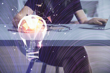 Double exposure of woman hands typing on computer and light bulb drawing. Idea concept.