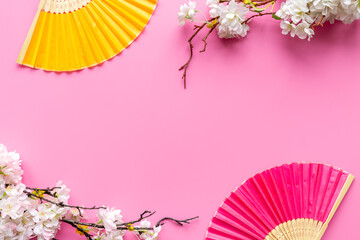 Asian background with hand fans and blossom branches