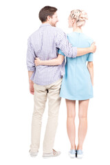 Vertical full length studio shot of modern Caucasian man and woman in love standing together embracing each other