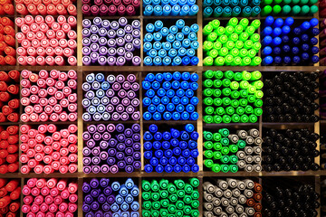 assortment of colorful pen stored in rack