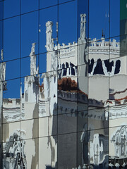 Deformed reflection  in a new building of a Neo Gothic church in the Quarter of Salamanca. Madrid....
