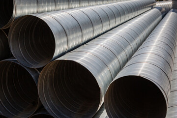 Ventilation pipe warehouse. Steel pipes, parts for the construction of air ducts for an industrial air conditioning system in a warehouse. Industrial airway ventilation equipment and piping systems