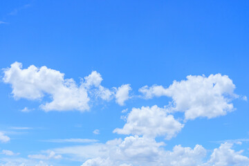 Naklejka na ściany i meble The sky is bright blue with beautiful fluffy clouds.
