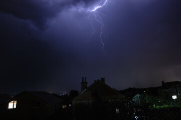 Beautiful lightning flashes in the evening sky during a thunderstorm