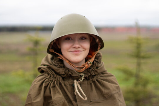 The girl in a military helmet. A woman in the uniform of a soldier of the Second World War.