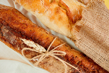 Top view of two baguette bread on a textile surface.
