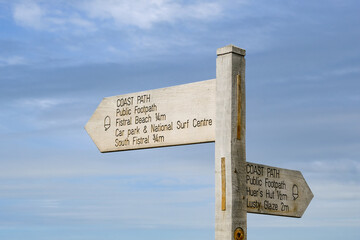 Signpost along the coastal path at Newquay, Cornwall, UK. 