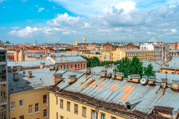 Fototapeta na wymiar Panoramic view of the city and the beautiful roofs of the city on a sunny day. Saint Petersburg, Russia - 26 June 2021