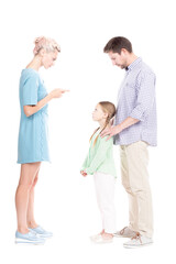 Vertical studio side view portrait of young adult parents telling their daughter off for bad behavior, white background