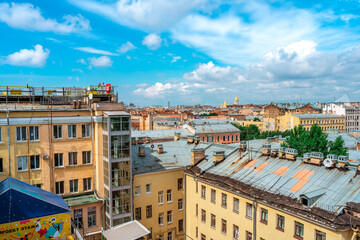 Naklejka na ściany i meble Panoramic view of the city and the beautiful roofs of the city on a sunny day. Saint Petersburg, Russia - 26 June 2021