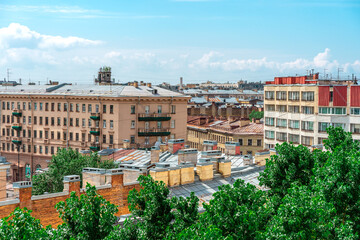 Fototapeta na wymiar Panoramic view of the city and the beautiful roofs of the city on a sunny day. Saint Petersburg, Russia - 26 June 2021
