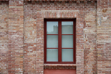 Detail of a square window in a brick wall