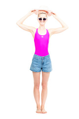 Vertical full length studio portrait of young Caucasian woman wearing summer outfit posing on camera with hat, white background