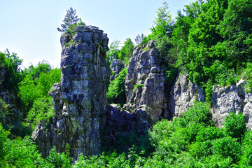 Fototapeta na wymiar Travertine rock with climber in Dreveník Slovakia, the area is also called as heaven