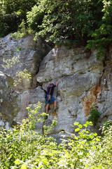 A climber climbs a travertine wall in Dreveník Slovakia