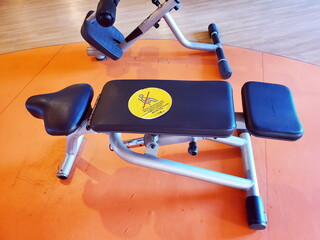 Yellow sticker warning about keeping social distance in Turkish, English, German, Russian languages. Social distancing caution sign on sport bench of gym equipment. Text - keep social distance