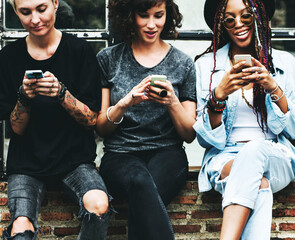 Fototapeta na wymiar Women Use Mobile Phone Together