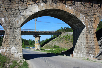 Old stone railway bridge over the road
