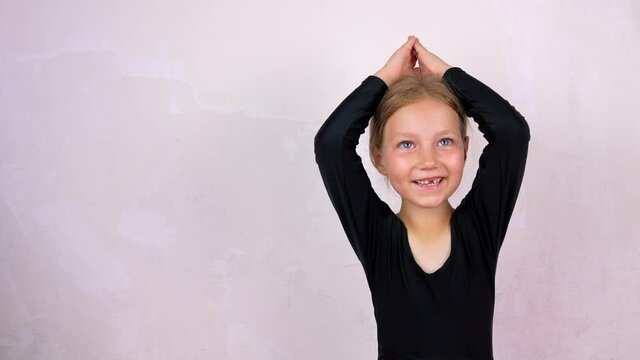 Little girl on yoga class in Siddhasana lotus pose on mat smiling. Online stretching practicing for children, flexibility health care active lifestyle sport. Wellness training at home 4K. New normal