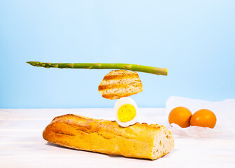 Fresh Bread, Asparagus and Egg. Ingridients for Breakfast. Equilibrium floating food. Balance levitation Food. Healthy Vitamin Eating.