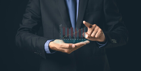 Businessman or trader is showing a growing virtual hologram stock, invest in trading.planning and strategy, Stock market.