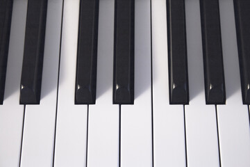 Part of the keyboard of a piano in white color