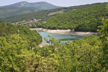 Fototapeta na wymiar Novoulyanovskoe reservoir, Bakhchisarai district, Crimea, Russia, top view - emerald lovely lake in the mountains.