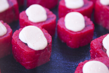 Assorted sushi food on a black slate plate